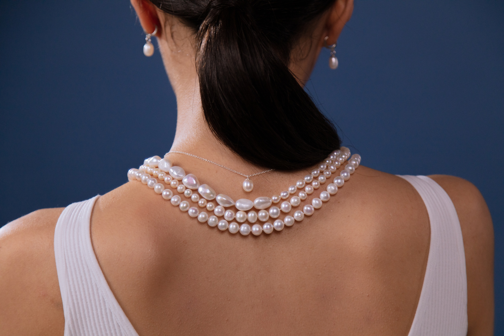 Woman Wearing White Pearl Necklace